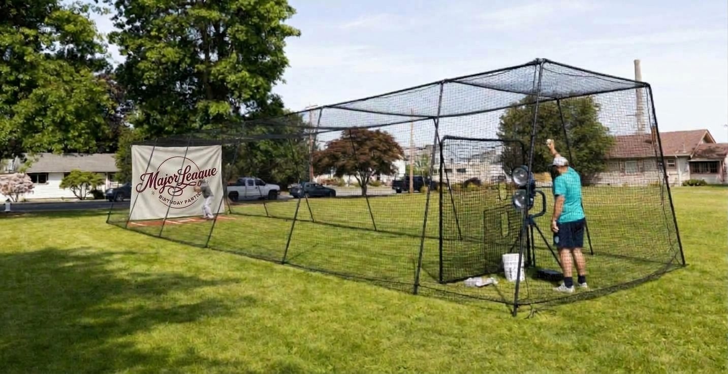 Batting cage and pitching machine set up on a lawn for a backyard baseball birthday party